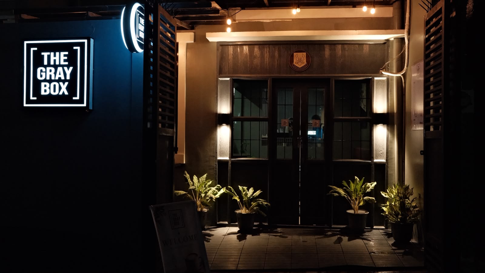 Café storefront lit up at night